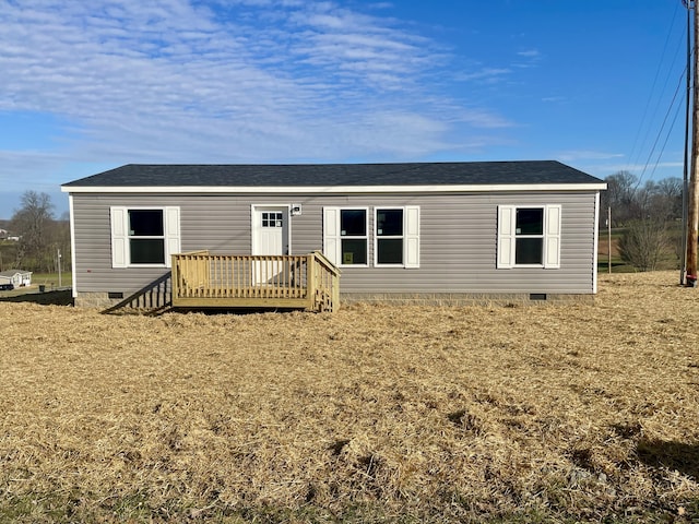 view of front of home with a wooden deck and a front yard