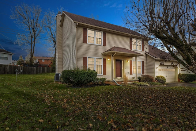 view of front of home featuring central AC unit, a garage, and a front lawn