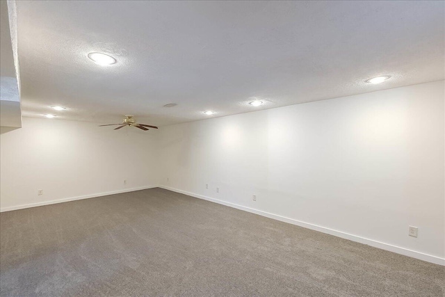 spare room featuring carpet and a textured ceiling