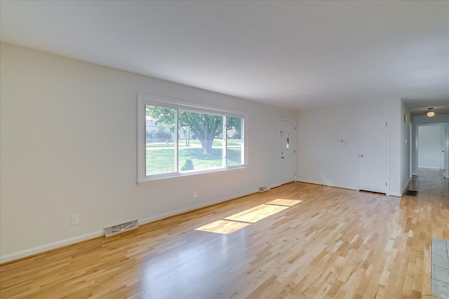 empty room with light hardwood / wood-style flooring