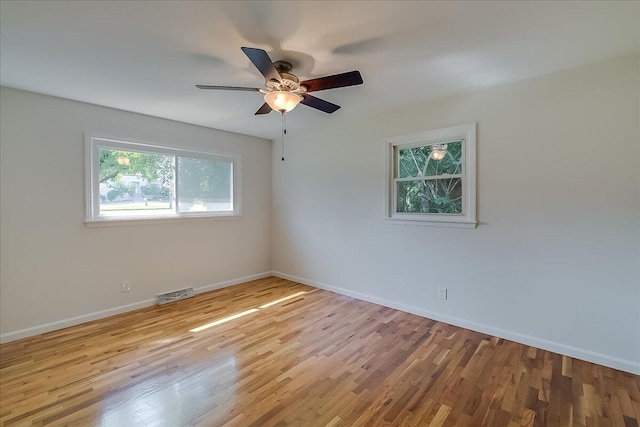 unfurnished room with ceiling fan and light wood-type flooring