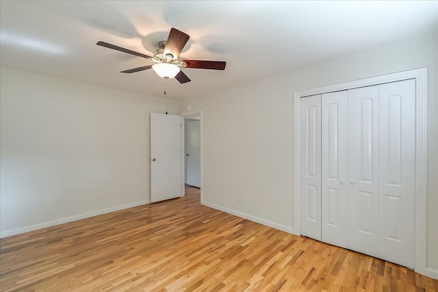 unfurnished bedroom featuring a closet, light hardwood / wood-style flooring, and ceiling fan