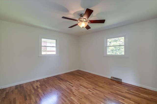 empty room with light hardwood / wood-style flooring and ceiling fan