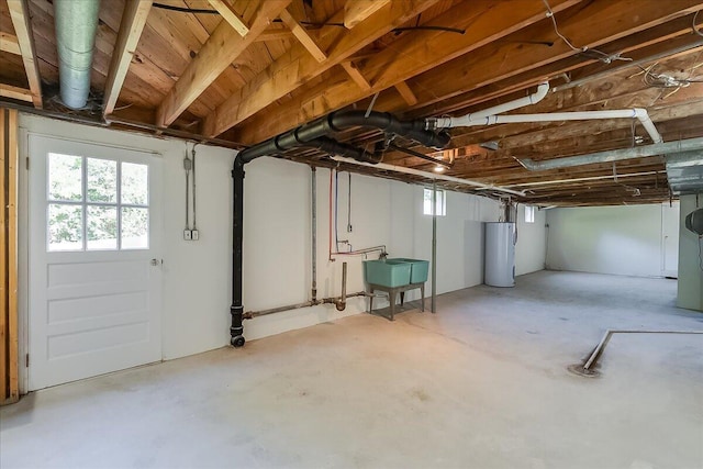 basement featuring sink and water heater