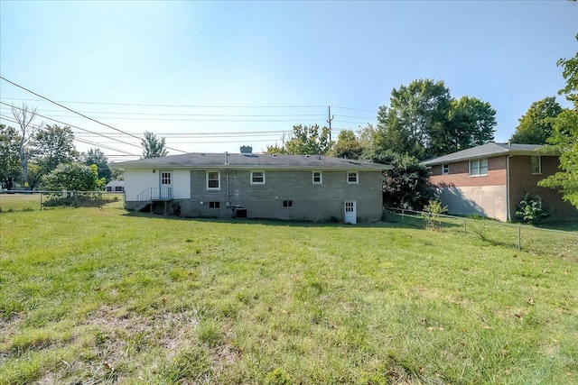 back of house featuring a yard and cooling unit