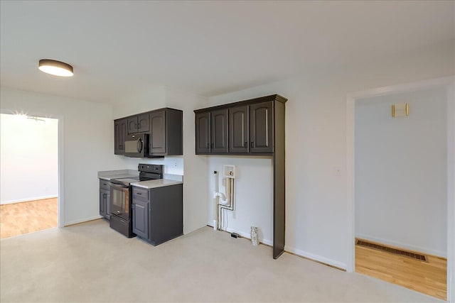 kitchen with dark brown cabinets and black / electric stove