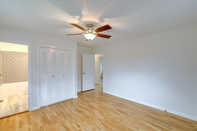 unfurnished bedroom featuring connected bathroom, a closet, ceiling fan, and light hardwood / wood-style flooring