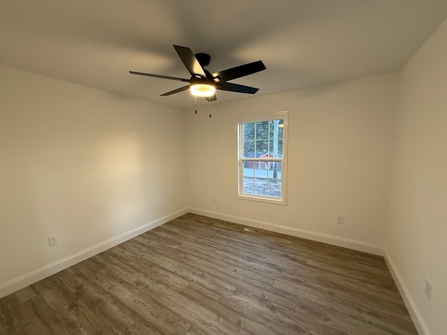 unfurnished room with hardwood / wood-style flooring and ceiling fan