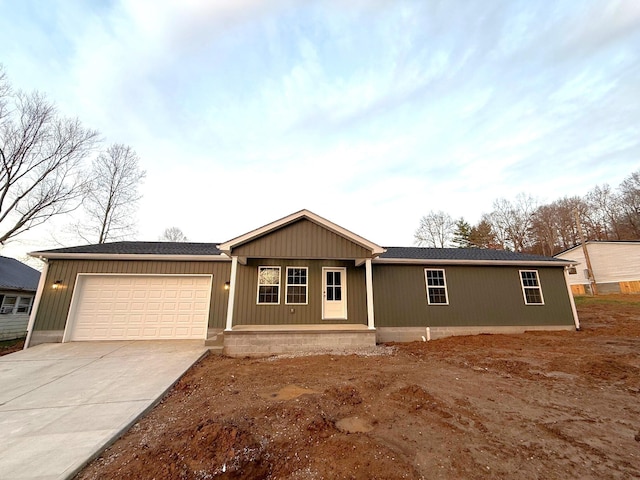 view of front facade featuring covered porch and a garage