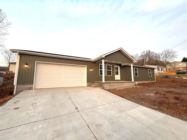 single story home featuring a porch and a garage