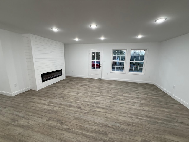 unfurnished living room with a fireplace and hardwood / wood-style floors