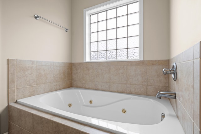 bathroom with a relaxing tiled tub