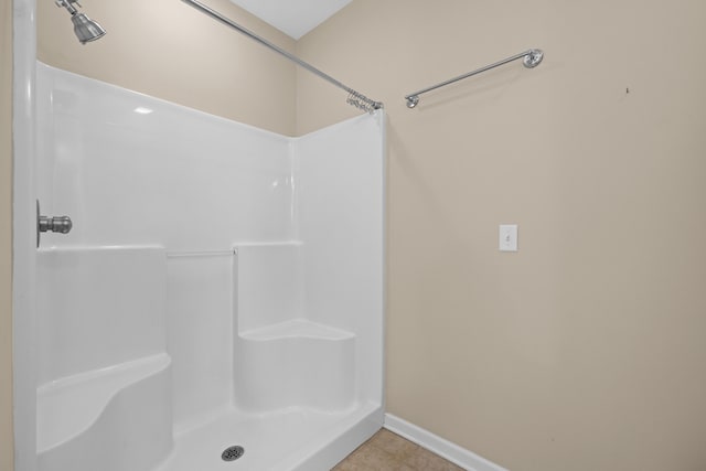 bathroom with tile patterned flooring and a shower