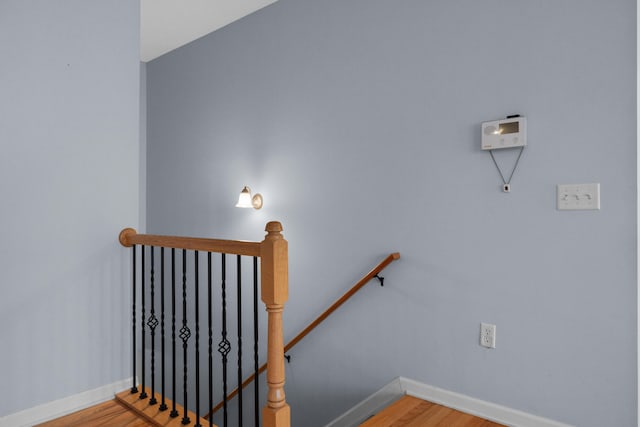 stairway with hardwood / wood-style floors