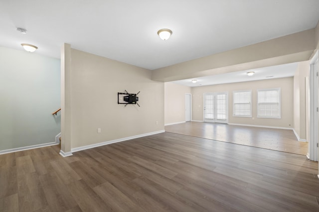 unfurnished room with dark wood-type flooring