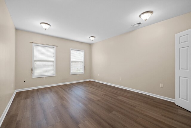 unfurnished bedroom featuring dark wood-type flooring