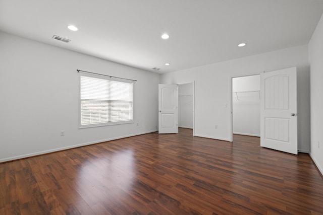 unfurnished bedroom with recessed lighting, visible vents, baseboards, and dark wood finished floors