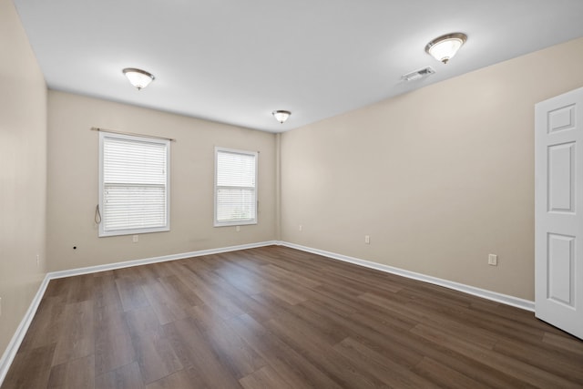 spare room with dark hardwood / wood-style flooring