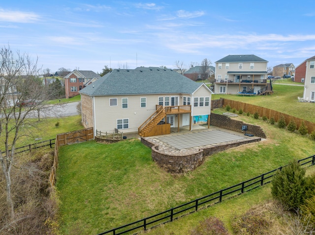 back of property featuring a patio area, stairway, a lawn, and a fenced backyard