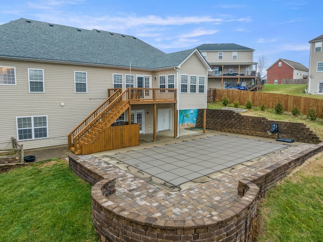 back of house with stairway, a patio area, fence, and a wooden deck