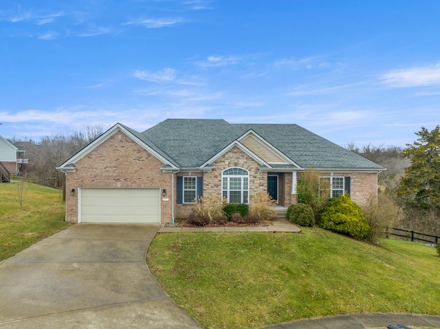 view of front of home featuring a garage and a front lawn