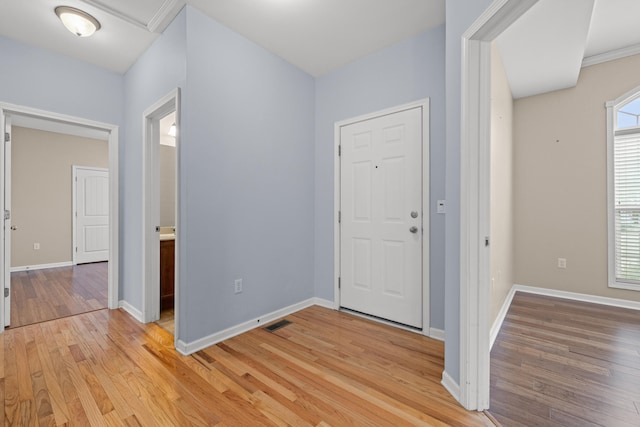 foyer featuring visible vents, baseboards, and light wood-style floors