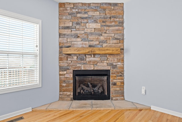 room details featuring a fireplace and wood-type flooring