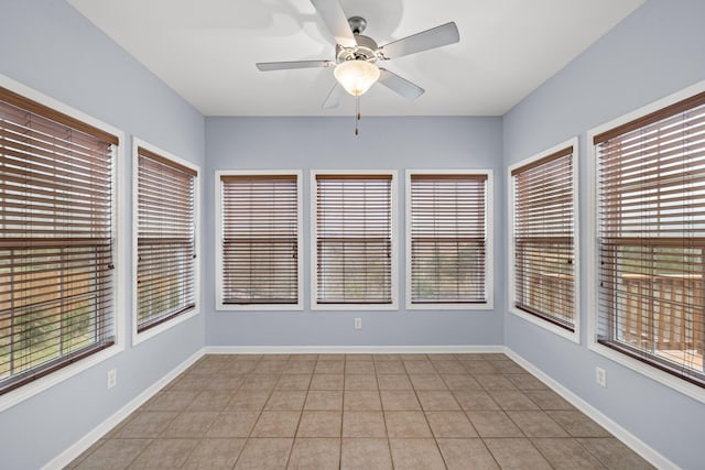 unfurnished sunroom with ceiling fan