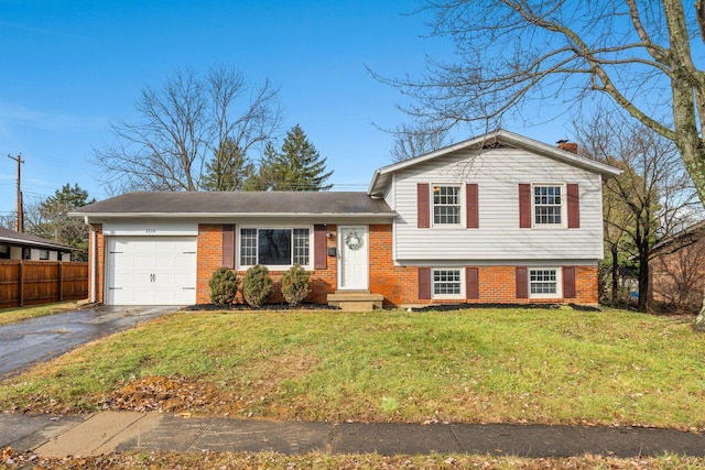 tri-level home with a front yard and a garage