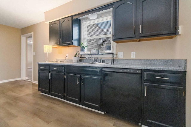 kitchen featuring dishwasher, hardwood / wood-style floors, and sink