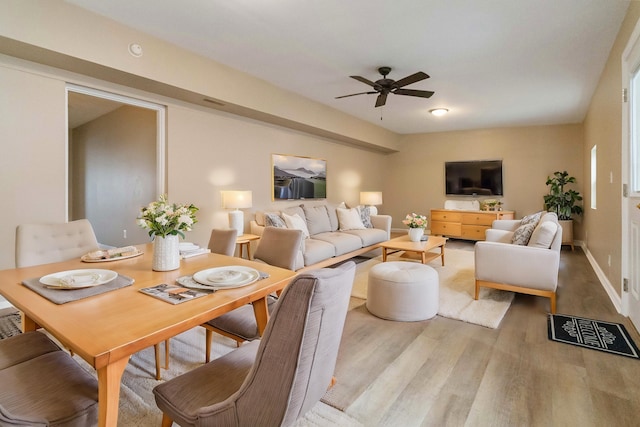 living room featuring light hardwood / wood-style flooring and ceiling fan