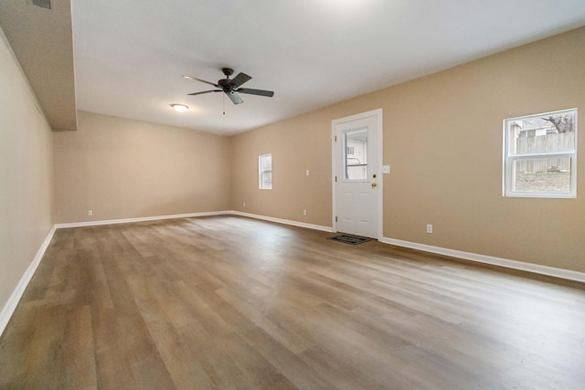 spare room featuring ceiling fan and light hardwood / wood-style floors