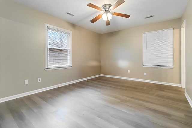 empty room featuring hardwood / wood-style floors and ceiling fan