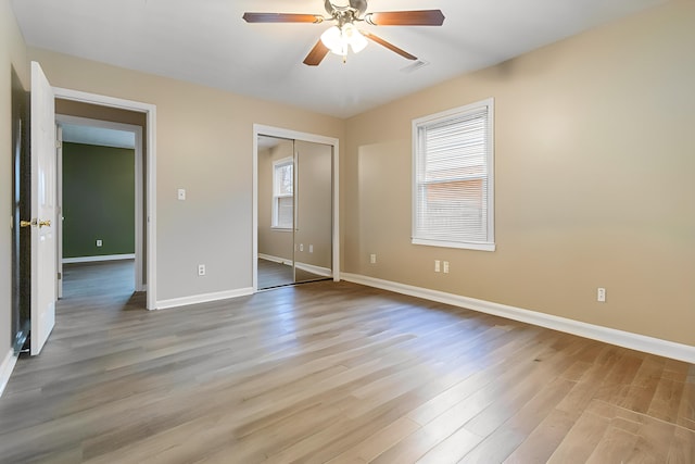 unfurnished bedroom featuring a closet, ceiling fan, and light hardwood / wood-style flooring