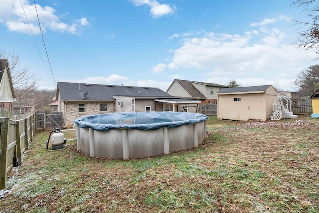 view of yard with a covered pool and a storage shed