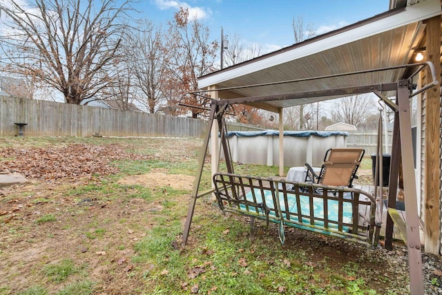 view of yard with a covered pool