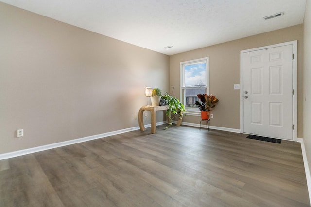 foyer entrance with wood-type flooring and a textured ceiling