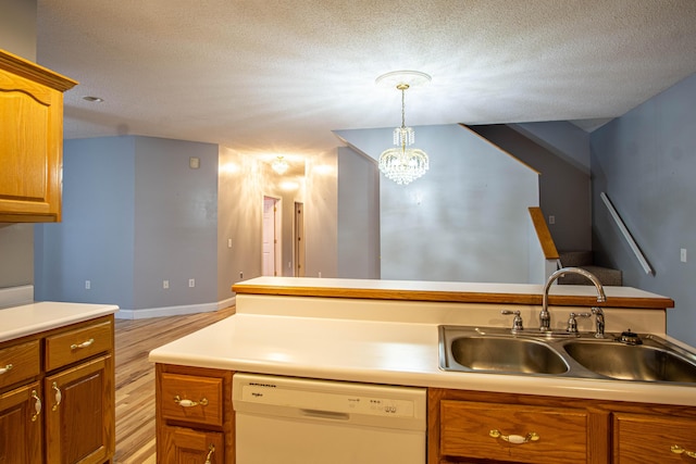 kitchen with a textured ceiling, sink, dishwasher, a chandelier, and hanging light fixtures