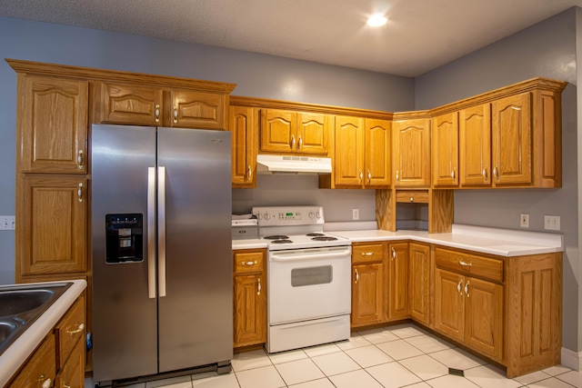 kitchen featuring stainless steel fridge, white electric range, sink, and light tile patterned floors