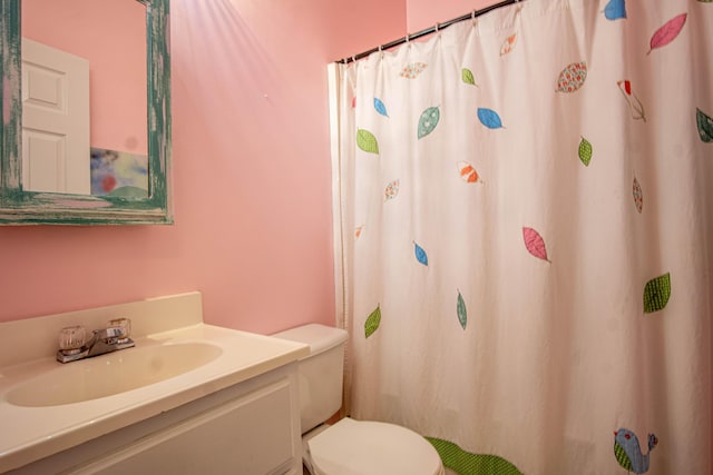 bathroom featuring vanity and toilet