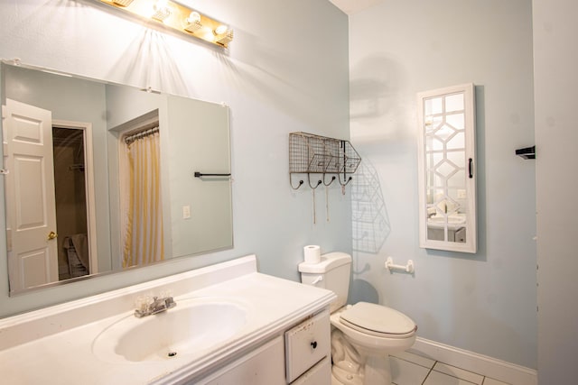 bathroom featuring tile patterned floors, vanity, and toilet