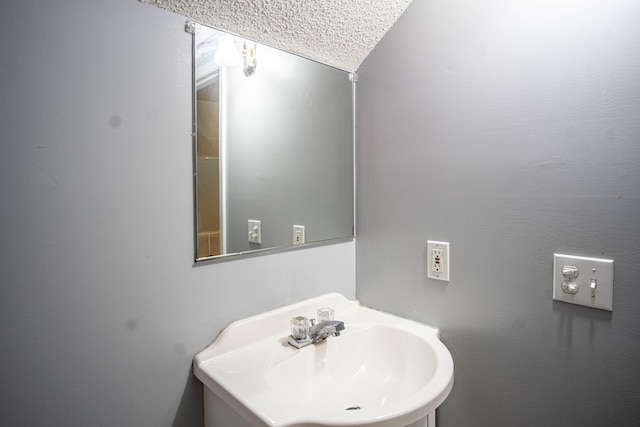 bathroom with a textured ceiling and sink