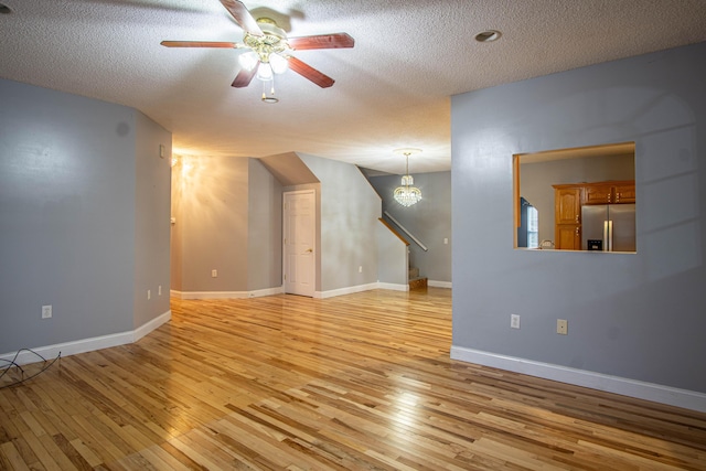 bonus room with ceiling fan, light hardwood / wood-style floors, and a textured ceiling