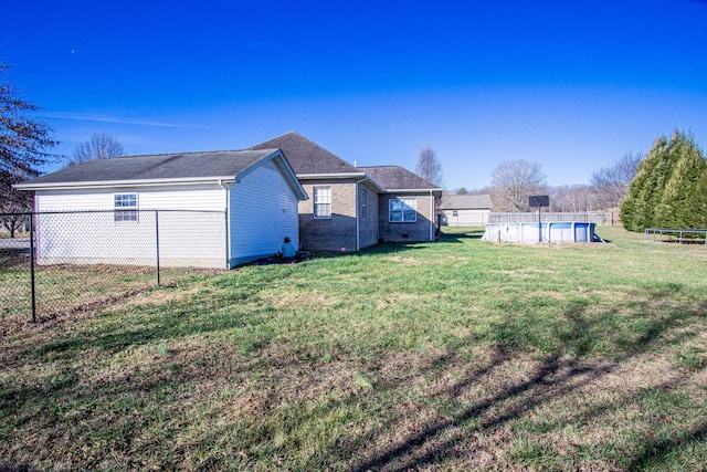 view of yard with a fenced in pool