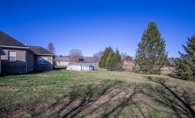 view of yard featuring a fenced in pool