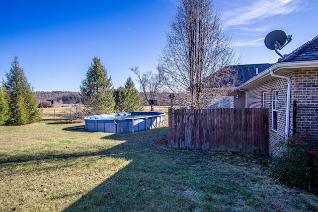 view of yard with a covered pool