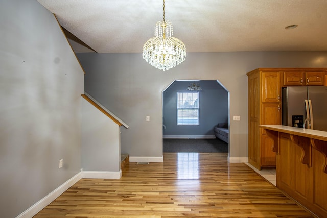 interior space featuring light hardwood / wood-style floors and a chandelier