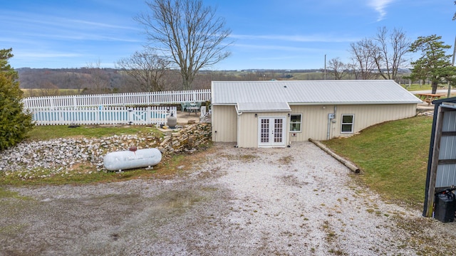 rear view of house featuring french doors