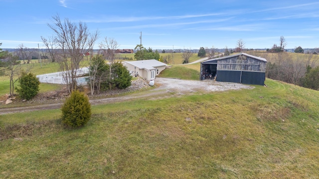 view of yard with an outbuilding and a rural view