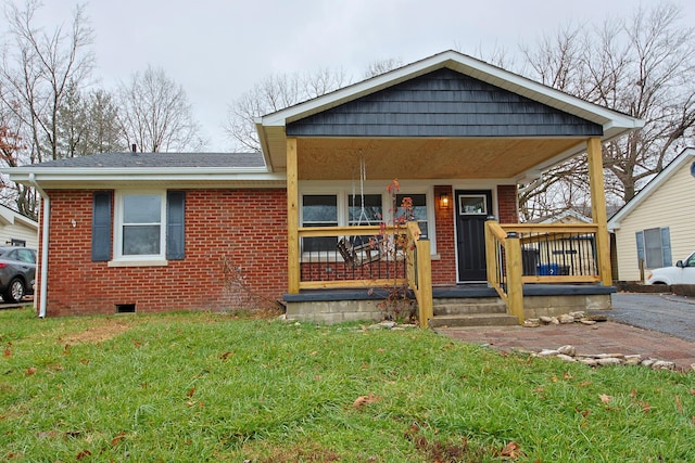 bungalow featuring a porch and a front lawn